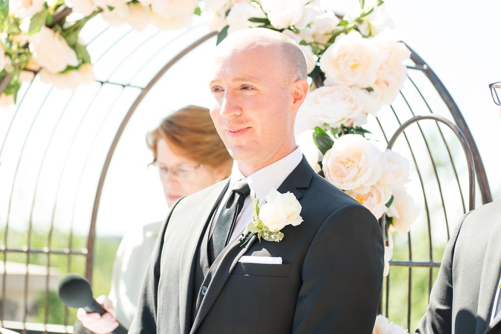 Groom excitedly waiting for his bride at the alter