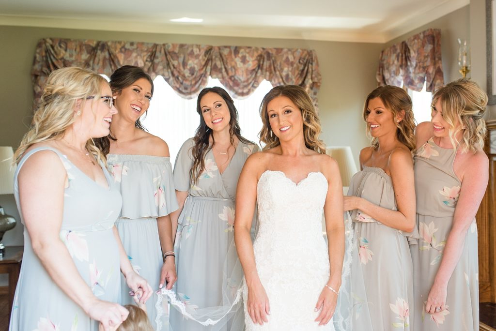 Bride getting ready with the help of her bridesmaids
