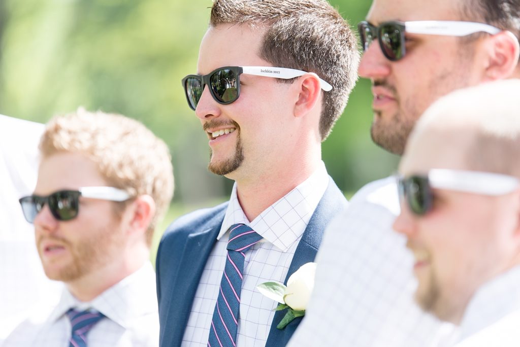Groomsman wearing wedding sunglasses and navy suit