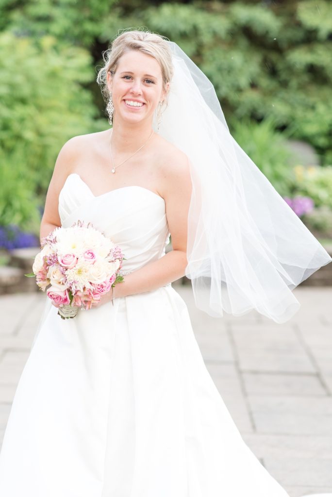Bride in a satin dress giggles at camera
