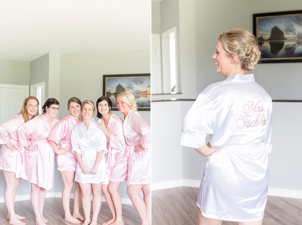 Bridesmaids posing with bride in pink silk robes
