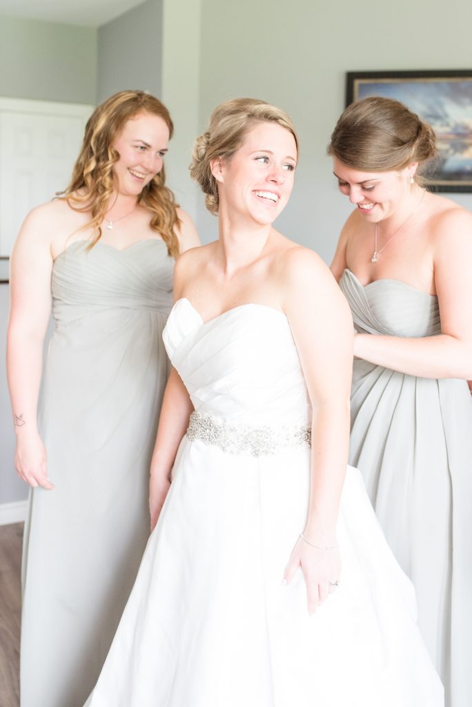 Maid of honour helping bride get ready