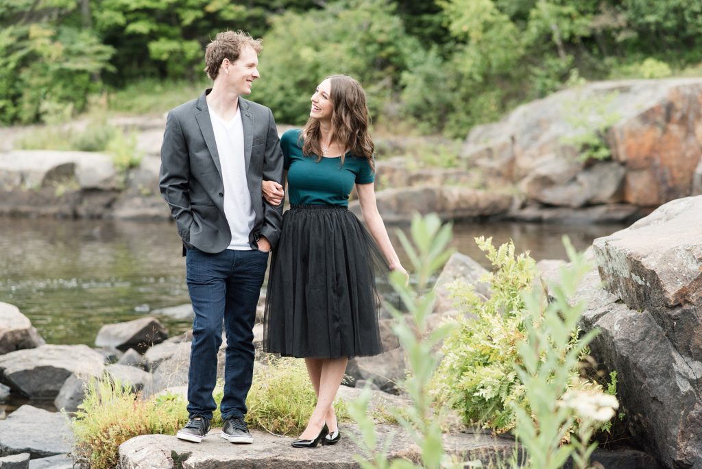 Bride and groom to be walk arm in arm during their Thunder Bay summer engagement session