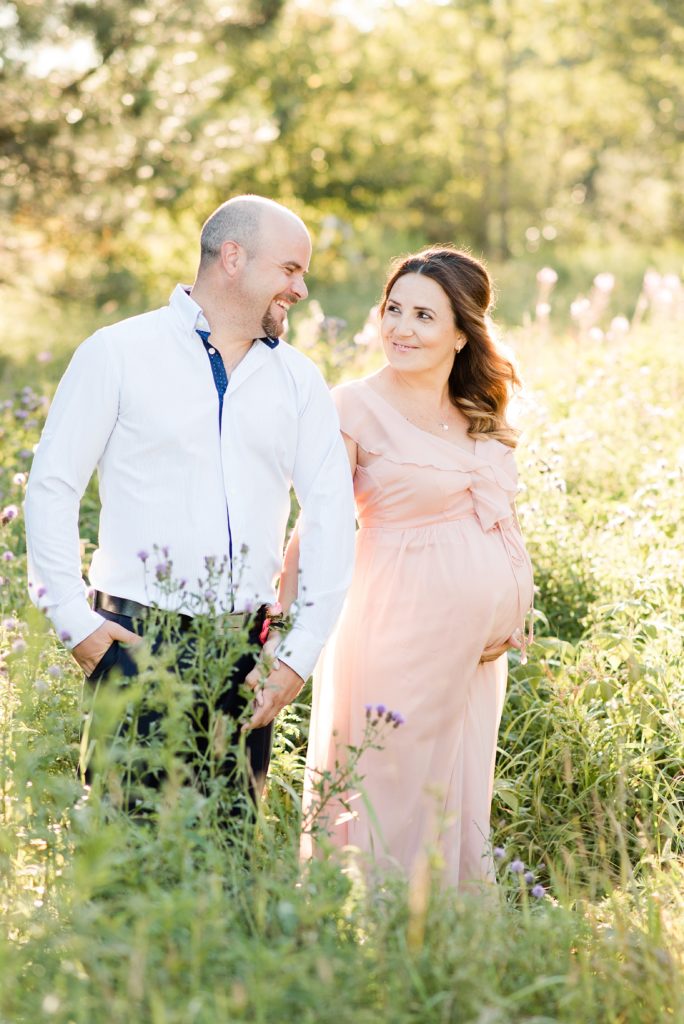Thunder Bay maternity session in August. Mom and dad to be laugh together. Mom-to-be is wearing a beautiful gown from Lulu