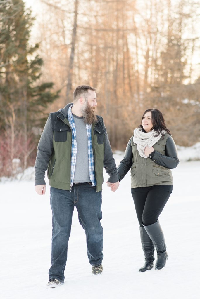 Bride and groom to be walking out at Wild Goose Beach during their Thunder Bay Winter Engagement Session