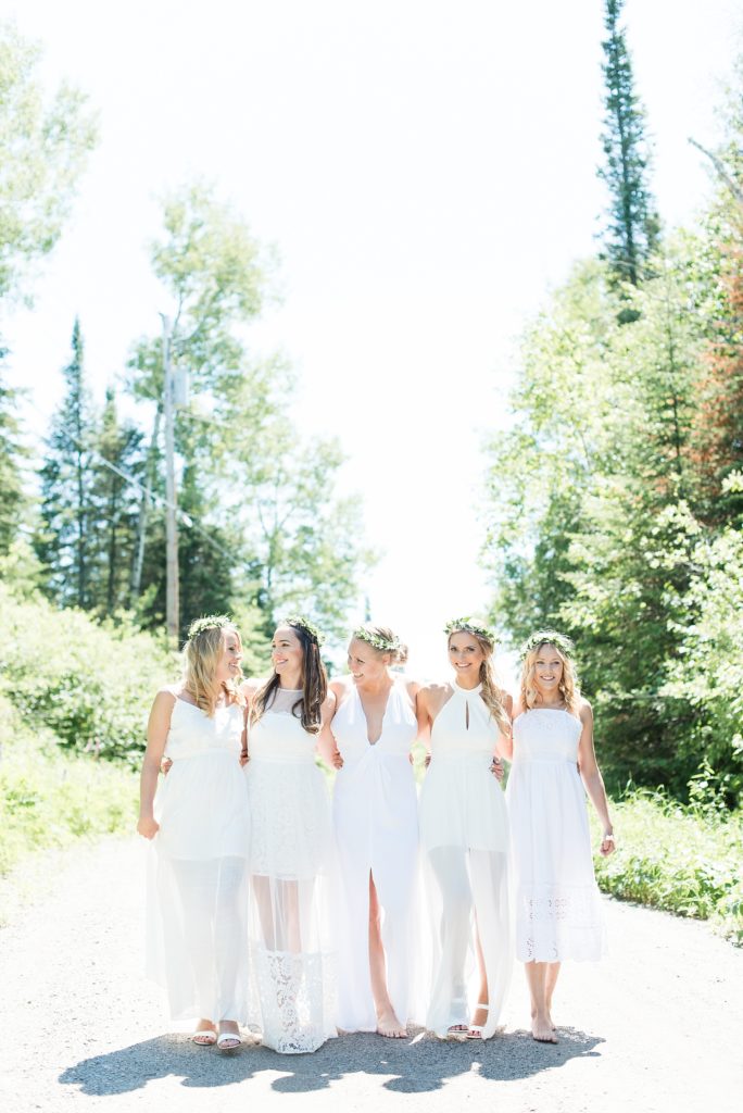 Cousins and friends walk down a dirt road just outside of Thunder Bay during their summer photo shoot