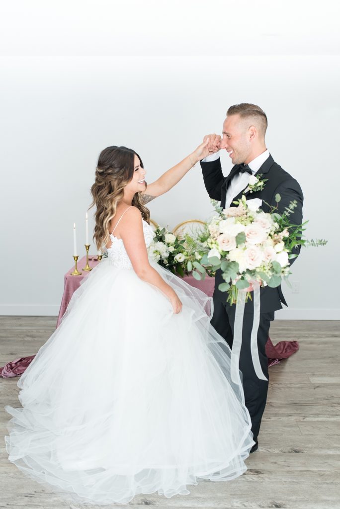Groom twirls his bride in front of their head table