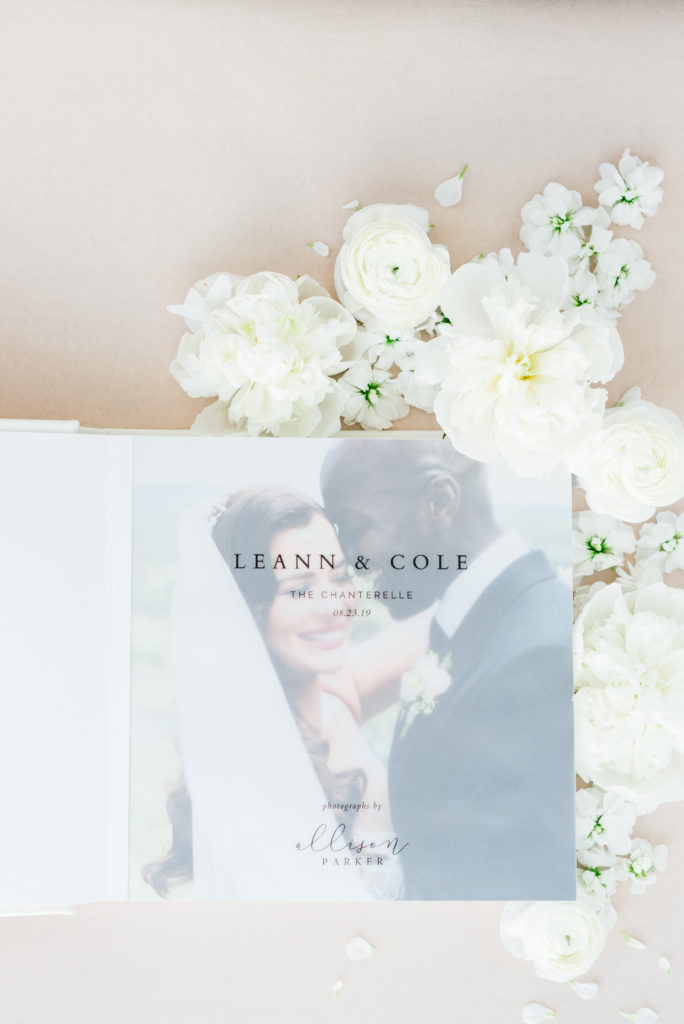 Wedding album featuring a vellum entrance page with the words "Leann & Cole, The Chanterelle, 08.23.19" inscribed on it.