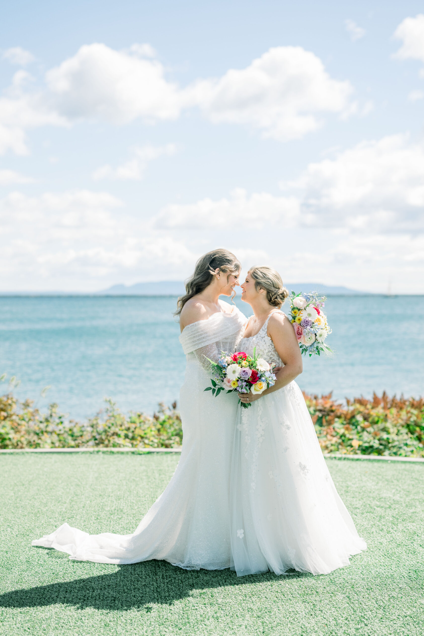 Two brides embracing on their wedding day at Marina Park in Thunder Bay